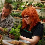 person making a kokedama