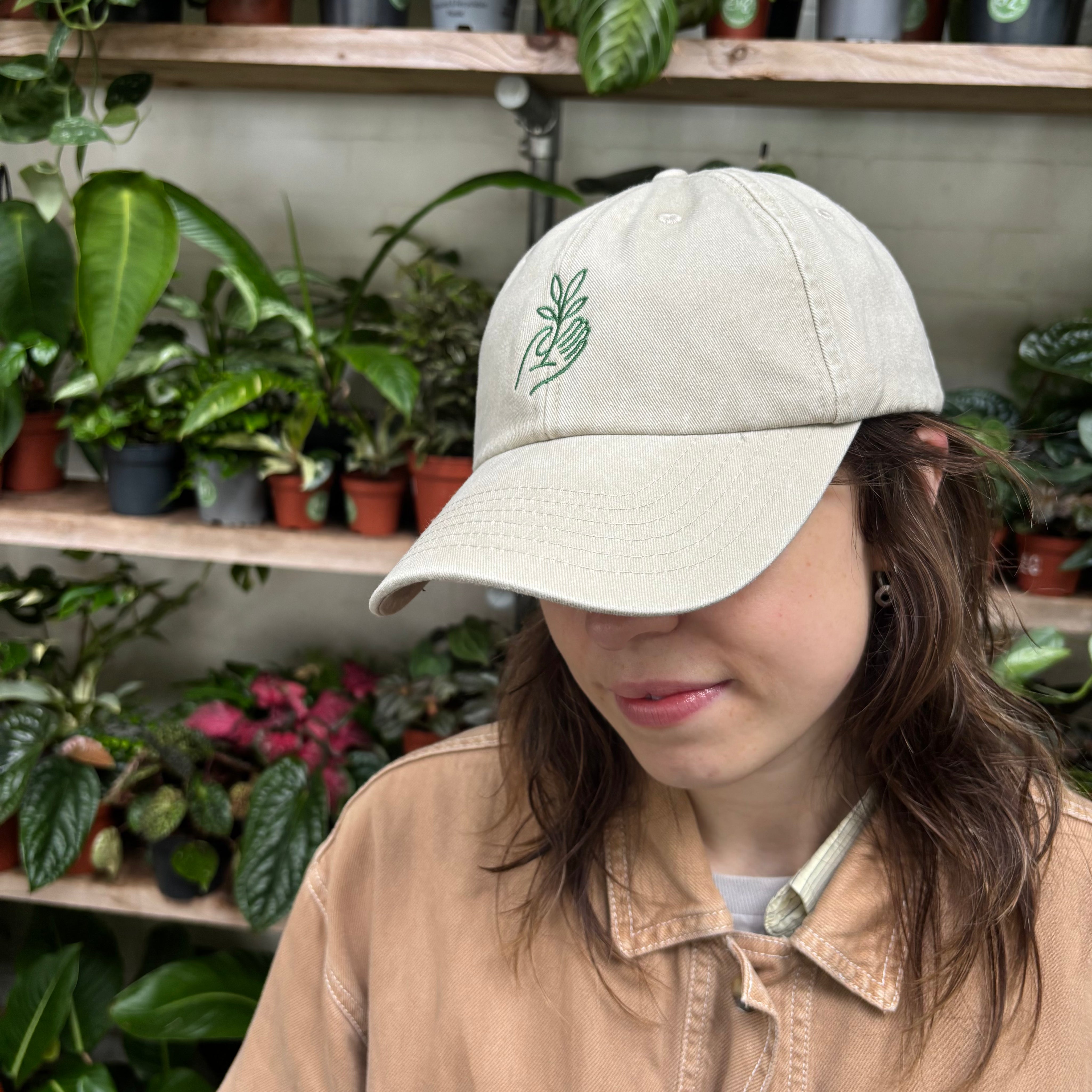 Cap in Sand with Green Logo at The Watered Garden