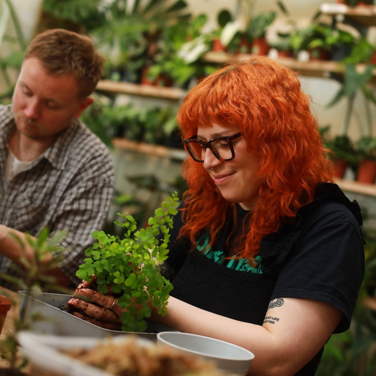 person making a kokedama
